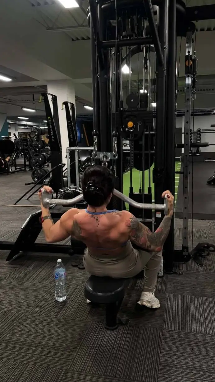 Sylwia doing a back exercise on the cable machine